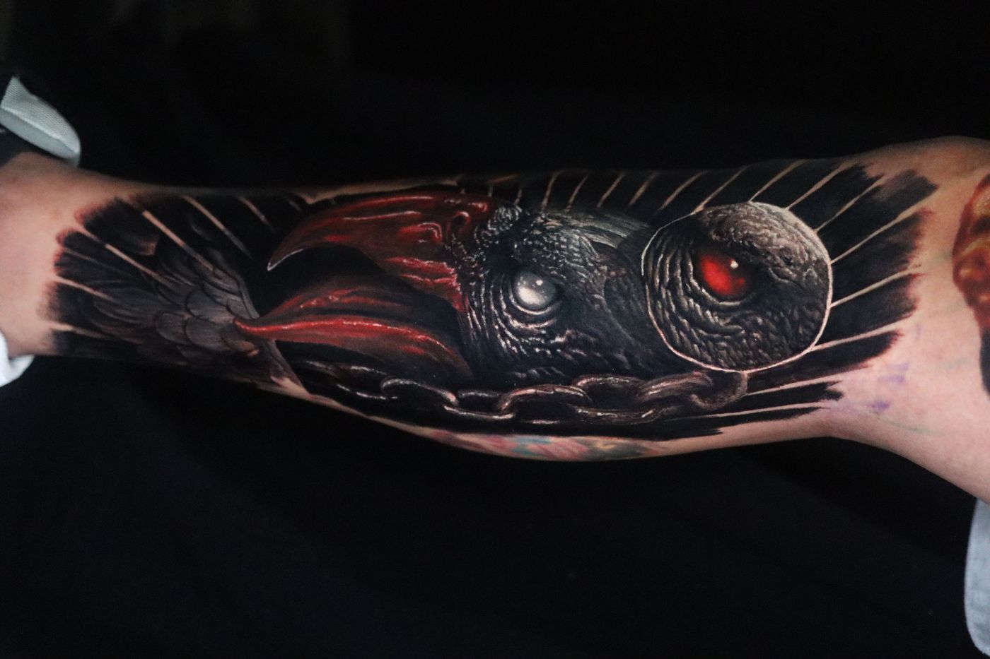 Dark realism eye and owl forearm tattoo