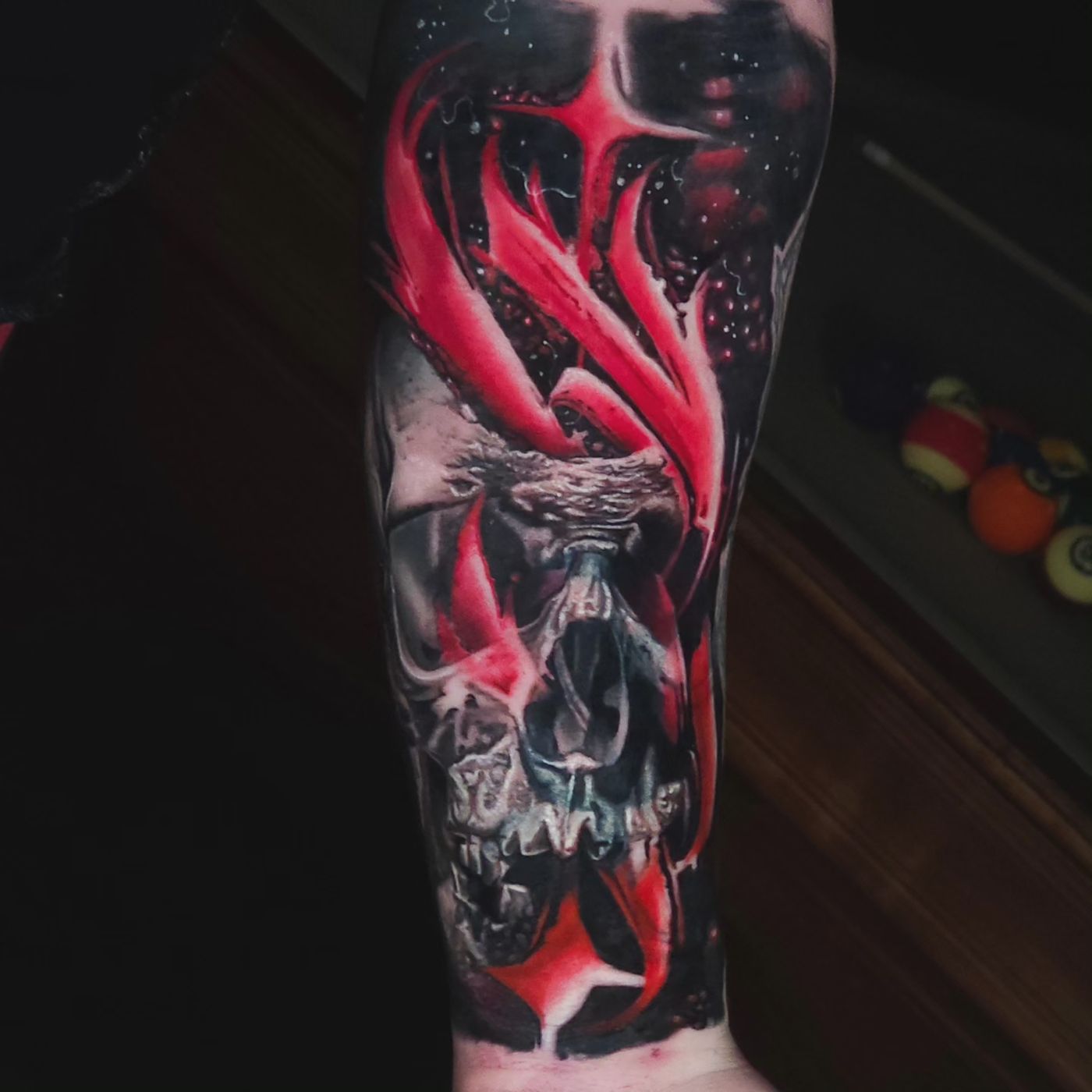 Red and black skull and flame sleeve tattoo