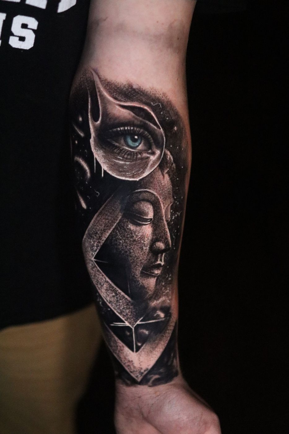 Surreal eye and face black and grey realism forearm tattoo