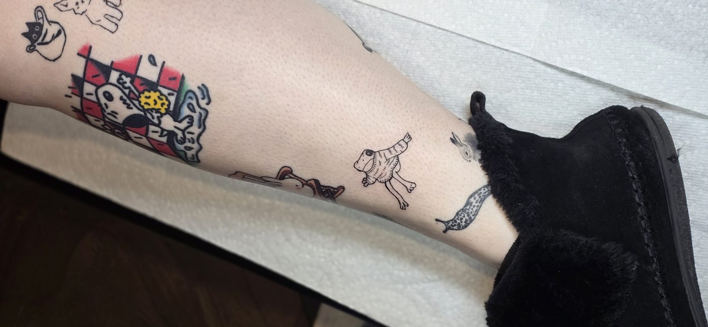 Collection of small flash tattoos on the leg